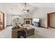 Comfortable living room with a fireplace, vaulted ceiling, and large windows offering backyard views at 6629 Woodcrest Dr, Avon, IN 46123