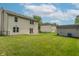 Expansive backyard with green lawn, patio, storage shed, and mature trees at 6635 Blackthorn Dr, Indianapolis, IN 46221