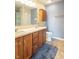 Traditional bathroom featuring a double sink vanity with wooden cabinets and blue wall paint at 6635 Blackthorn Dr, Indianapolis, IN 46221
