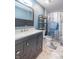 Stylish bathroom with a modern vanity, a gray cabinet, and a blue-themed shower curtain at 6635 Blackthorn Dr, Indianapolis, IN 46221