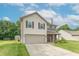Well-maintained two-story home featuring a spacious driveway, attached garage, and vibrant lawn at 6635 Blackthorn Dr, Indianapolis, IN 46221