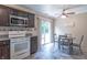 Bright kitchen features stainless appliances, countertop microwave, and adjacent eat in space at 6635 Blackthorn Dr, Indianapolis, IN 46221