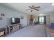 Spacious living room with neutral carpet, ceiling fan, and seamless flow to the upper floor at 6635 Blackthorn Dr, Indianapolis, IN 46221
