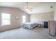 Bright main bedroom featuring two windows and a ceiling fan with carpeted floor at 6635 Blackthorn Dr, Indianapolis, IN 46221