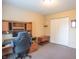 Functional office space with a computer desk, neutral walls and carpet flooring at 6635 Blackthorn Dr, Indianapolis, IN 46221