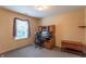 Well-lit office with neutral walls, a wooden desk, and carpet flooring at 6635 Blackthorn Dr, Indianapolis, IN 46221