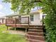 Home's backyard deck with seating area and stairs leading down to the lawn at 6637 Sundown S Dr, Indianapolis, IN 46254