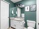 Stylish bathroom with modern fixtures, including a framed mirror, a white sink, and framed art at 6637 Sundown S Dr, Indianapolis, IN 46254