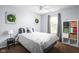Cozy bedroom featuring neutral paint, a ceiling fan, and a window providing natural light at 6637 Sundown S Dr, Indianapolis, IN 46254