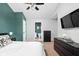 Bedroom with ensuite bathroom, wall-mounted TV, and dark wood furniture at 6637 Sundown S Dr, Indianapolis, IN 46254