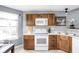 Bright kitchen with dark-wood cabinets, white appliances, and a decorative backsplash at 6637 Sundown S Dr, Indianapolis, IN 46254