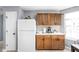 Well-lit kitchen with a refrigerator, dark-wood cabinets, and ample counter space at 6637 Sundown S Dr, Indianapolis, IN 46254