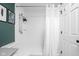 Updated white tiled walk-in shower with a rainfall showerhead, and a white shower curtain at 6637 Sundown S Dr, Indianapolis, IN 46254