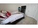Bedroom with neutral carpet, bed, television, and a view of the closet door at 6842 Arrowhead Dr, Brownsburg, IN 46112