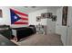 A well lit bedroom with neutral carpet and comic book art at 6842 Arrowhead Dr, Brownsburg, IN 46112
