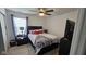 Cozy bedroom featuring neutral carpet, ceiling fan, and a bed next to the window at 6842 Arrowhead Dr, Brownsburg, IN 46112