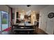 Dining area next to open kitchen with dark wood table, bench and chairs at 6842 Arrowhead Dr, Brownsburg, IN 46112