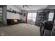 Bright game room boasts large window with red curtains, black futon and shelving for decorations at 6842 Arrowhead Dr, Brownsburg, IN 46112