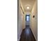 Hallway with dark wood floors and closet, showing access to another room in the home at 6842 Arrowhead Dr, Brownsburg, IN 46112