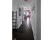 Hallway with dark hardwood floors leading to a cozy living area with a fireplace and decor at 6842 Arrowhead Dr, Brownsburg, IN 46112