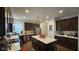 Modern kitchen featuring stainless steel appliances, a large island, and dark brown cabinets at 6842 Arrowhead Dr, Brownsburg, IN 46112