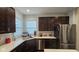 Kitchen with white countertops, stainless steel appliances, and dark brown cabinets at 6842 Arrowhead Dr, Brownsburg, IN 46112
