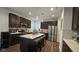 Modern kitchen featuring stainless steel appliances, a large island, and dark brown cabinets at 6842 Arrowhead Dr, Brownsburg, IN 46112