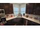Kitchen with white countertops, stainless steel appliances, and dark brown cabinets at 6842 Arrowhead Dr, Brownsburg, IN 46112