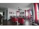 Open-concept living room with hardwood floors, gray sofas, red accents, and modern decor at 6842 Arrowhead Dr, Brownsburg, IN 46112