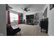 Comfortable living room with large window, TV, and carpeted floor at 6842 Arrowhead Dr, Brownsburg, IN 46112