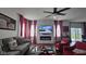 Cozy living room featuring a modern fireplace, gray sofas, red accents, and bright windows at 6842 Arrowhead Dr, Brownsburg, IN 46112