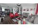 Spacious living room with a view into the kitchen, featuring hardwood floors and gray sofas at 6842 Arrowhead Dr, Brownsburg, IN 46112