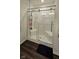 Close-up of the shower with a clear sliding glass door and bronze hardware at 6842 Arrowhead Dr, Brownsburg, IN 46112