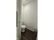 Bathroom with wood-look floor, toilet and trash can at 6842 Arrowhead Dr, Brownsburg, IN 46112