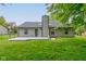 The backyard features a gray deck and an expanse of grass at 7239 Wet Rock Ct, Indianapolis, IN 46236