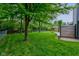 Fenced backyard featuring a well-manicured lawn, plenty of trees, and a shed at 7239 Wet Rock Ct, Indianapolis, IN 46236
