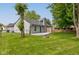 A well-maintained backyard features a deck, a fire pit, and mature shade trees at 7239 Wet Rock Ct, Indianapolis, IN 46236