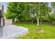 Spacious backyard features a deck, lush lawn, mature trees, and a charming fire pit area at 7239 Wet Rock Ct, Indianapolis, IN 46236