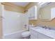 Bright bathroom features a shower-tub combo and a vanity with a marble countertop at 7239 Wet Rock Ct, Indianapolis, IN 46236