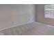 This bedroom has a window, outlets, and light-colored carpet at 7239 Wet Rock Ct, Indianapolis, IN 46236