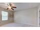 This bedroom has a ceiling fan, a window, and small floating shelves at 7239 Wet Rock Ct, Indianapolis, IN 46236