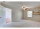 This bedroom has light-colored carpet, a ceiling fan, and a large window at 7239 Wet Rock Ct, Indianapolis, IN 46236