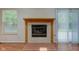 Stylish living room fireplace with tile surround, hardwood floors, and large window at 7239 Wet Rock Ct, Indianapolis, IN 46236