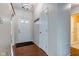 Bright foyer with hardwood floors features a coat rack and entry to the bathroom at 7239 Wet Rock Ct, Indianapolis, IN 46236