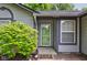 Inviting front entrance features a storm door, brick walkway and lush landscaping at 7239 Wet Rock Ct, Indianapolis, IN 46236