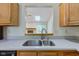 Open kitchen sink with stainless steel faucet and countertops, plus a view of the living room at 7239 Wet Rock Ct, Indianapolis, IN 46236