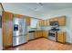 Well-lit kitchen with modern stainless steel appliances and lots of cabinet space at 7239 Wet Rock Ct, Indianapolis, IN 46236