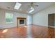 Bright living room featuring hardwood floors, fireplace, skylights, and ample natural light at 7239 Wet Rock Ct, Indianapolis, IN 46236