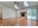 Open living room with hardwood floors, fireplace, skylight, and sliding patio door at 7239 Wet Rock Ct, Indianapolis, IN 46236