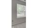 A window with white trim provides natural light and outdoor views in the house at 7239 Wet Rock Ct, Indianapolis, IN 46236